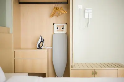 a room with a surfboard next to a bed at Zenstay Abnb Perai Penang in Bukit Mertajam