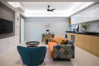 a living room with a couch and a kitchen at Zenstay Abnb Perai Penang in Bukit Mertajam