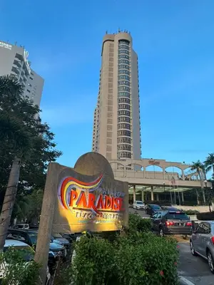 a sign in front of a parking lot with a tall building at Rainbow Paradise Homestay @ Tanjung Bungah by Landmark in Tanjung Bungah