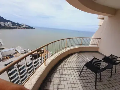 a balcony with two chairs and a view of the water at Rainbow Paradise Homestay @ Tanjung Bungah by Landmark in Tanjung Bungah
