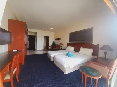 a hotel room with a large bed and a desk at Rainbow Paradise Homestay @ Tanjung Bungah by Landmark in Tanjung Bungah