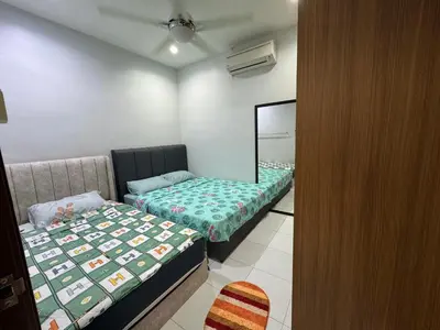 a small room with two beds and a mirror at Cozy House 37 @ Alma BM in Bukit Mertajam