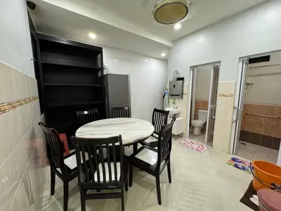 a dining room with a table and chairs and a bathroom at Cozy House 37 @ Alma BM in Bukit Mertajam