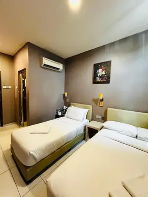a hotel room with two beds in a room at DS Hotel in Ipoh