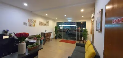 a living room with a couch and a table with plants at DS Hotel in Ipoh