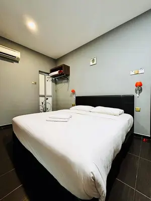 a large white bed sitting in a room at DS Hotel in Ipoh