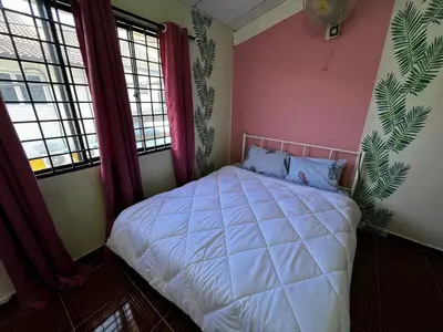 a bedroom with a white bed and two windows at Wan Homestay Kulim Hi-Tech Mslliim only in Kulim