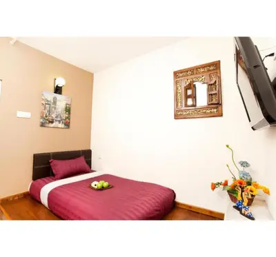 a bedroom with a bed with a bowl of fruit on it at Hotel O Vince Villa in Bukit Mertajam