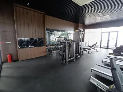 a gym with treadmills and machines in a room at Penang Georgetown KT Home for 8 pax in George Town