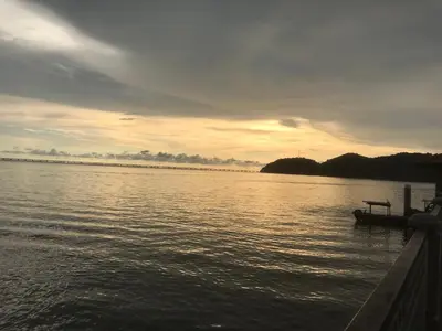 a boat on the water with a sunset in the background at Batu Kawan HS in Simpang Ampat