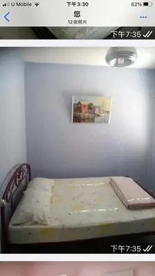 a bed in a room with a picture on the wall at Batu Kawan HS in Simpang Ampat