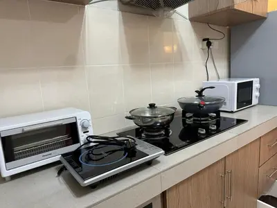 a kitchen with a microwave and a stove top oven at Little England B9 in Bukit Fraser
