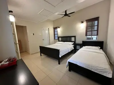a bedroom with two beds and a ceiling fan at Little England B9 in Bukit Fraser