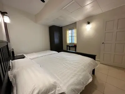 a bedroom with two beds with white sheets at Little England B9 in Bukit Fraser