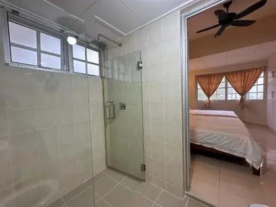 a bedroom with a glass shower and a bed at Little England B9 in Bukit Fraser