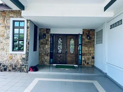 a front door of a house with a brick wall at Naura Roomstay in Sungai Petani