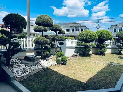 a backyard with a garden with bushes and trees at Naura Roomstay in Sungai Petani