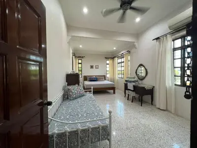 a living room with a couch and a ceiling fan at Naura Roomstay in Sungai Petani
