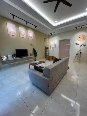 a living room with a couch and a table at The Five Cottage @ Botani Ipoh in Ipoh