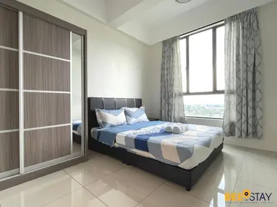 a bedroom with a bed and a large window at Ipoh Meru Casa Kayangan 3 Bedroom Apartment in Ipoh