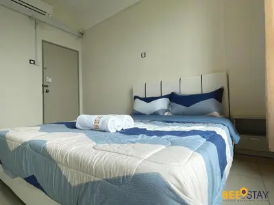 a bedroom with a large bed with two towels on it at Ipoh Meru Casa Kayangan 3 Bedroom Apartment in Ipoh