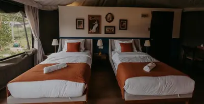 two twin beds in a room with a window at kMah@SomerMansion in Tanah Rata