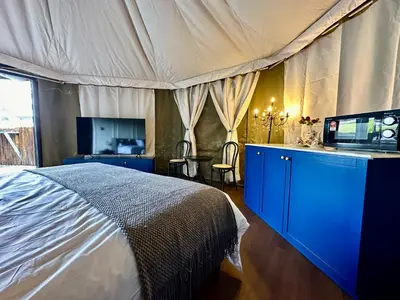 a bedroom with a bed and a television in it at kMah@SomerMansion in Tanah Rata