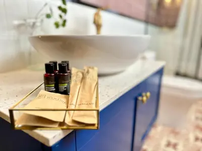 a bathroom counter with a sink and a white bowl at kMah@SomerMansion in Tanah Rata