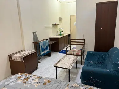 a living room with a couch and a table and a sink at Sofea Inn Bukit Merah - Laketown A6116 in Simpang Ampat Semanggol