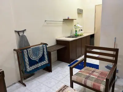 a kitchen with a bench and a sink and a chair at Sofea Inn Bukit Merah - Laketown A6116 in Simpang Ampat Semanggol