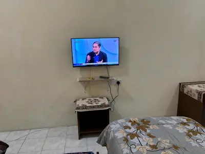 a flat screen tv hanging on a wall at Sofea Inn Bukit Merah - Laketown A6116 in Simpang Ampat Semanggol