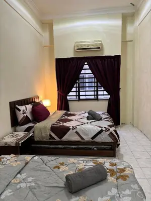 a bedroom with two beds and a window at Sofea Inn Bukit Merah - Laketown A6116 in Simpang Ampat Semanggol