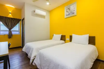 two beds in a room with yellow walls at Hidden 5BR Cottage House Retreats (Free Parking) in Butterworth