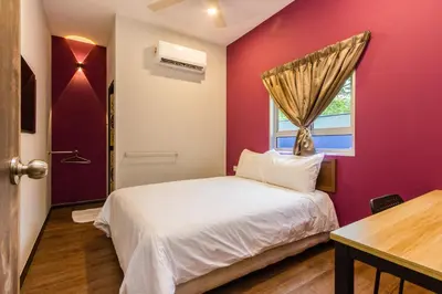 a bedroom with a white bed and a window at Hidden 5BR Cottage House Retreats (Free Parking) in Butterworth