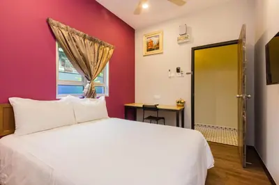 a bedroom with a white bed and a window at Hidden 5BR Cottage House Retreats (Free Parking) in Butterworth