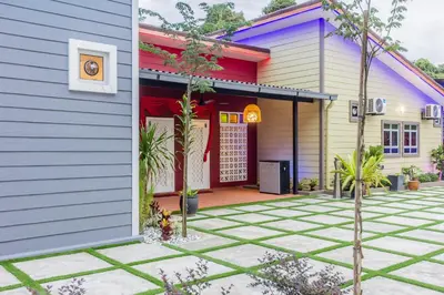 a colorful house with a courtyard in front of it at Hidden 5BR Cottage House Retreats (Free Parking) in Butterworth