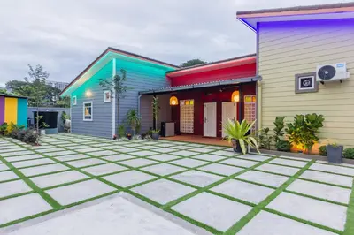 a colorful house with a courtyard in front of it at Hidden 4BR Cottage House Retreats (Free Parking) in Butterworth
