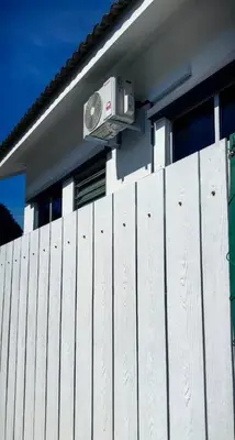 a white fence with a security camera on the side of a house at Mountain View Umoh50 Ipoh End-Lot Wi-fi Cozy in Ipoh