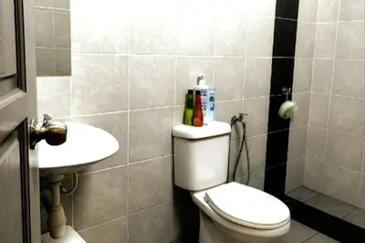 a bathroom with a toilet and a sink at Mountain View Umoh50 Ipoh End-Lot Wi-fi Cozy in Ipoh
