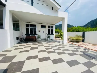 a white house with a checkered floor at Mountain View Umoh50 Ipoh End-Lot Wi-fi Cozy in Ipoh