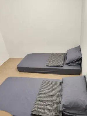 two beds sitting on a wooden platform in a room at Mountain View Umoh50 Ipoh End-Lot Wi-fi Cozy in Ipoh