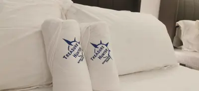 a bed with white pillows with the new york mets at TREASURE HUNTER At Heritage Georgetown in George Town