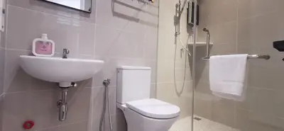 a bathroom with a toilet and a sink and a shower at TREASURE HUNTER At Heritage Georgetown in George Town