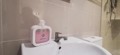 a soap bottle sitting on top of a sink in a bathroom at TREASURE HUNTER At Heritage Georgetown in George Town
