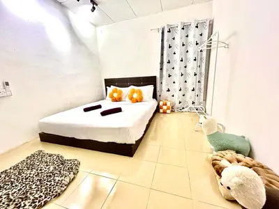 a bedroom with a bed with two stuffed animals on it at Cozy39#6pax#netflix#jpnstyle#NearAlma#5kmtoIconCity#BM in Bukit Mertajam