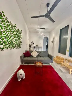 a living room with a couch and a red rug at Cozy39#6pax#netflix#jpnstyle#NearAlma#5kmtoIconCity#BM in Bukit Mertajam