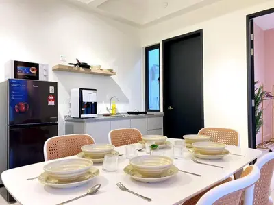 a white table with plates and utensils on it at Jovial Modern&Stylish `UrbanSuites in Jelutong
