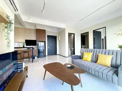 a living room with a couch and a table at Jovial Modern&Stylish `UrbanSuites in Jelutong