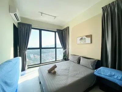 a bedroom with a bed and a large window at Jovial Modern&Stylish `UrbanSuites in Jelutong