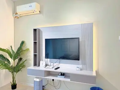 a television on a white shelf in a room at Sekinchan 2008 Homestay \u60a6\u5ba2 \u6cd5\u5f0f\u5976\u6cb9\u98ce\u6c11\u5bbf in Sekincan